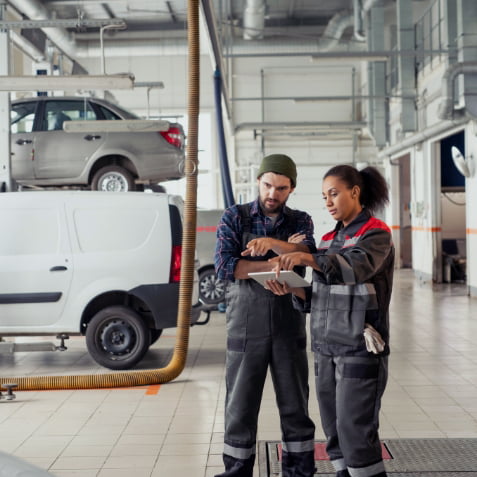 Two autobody workers at work