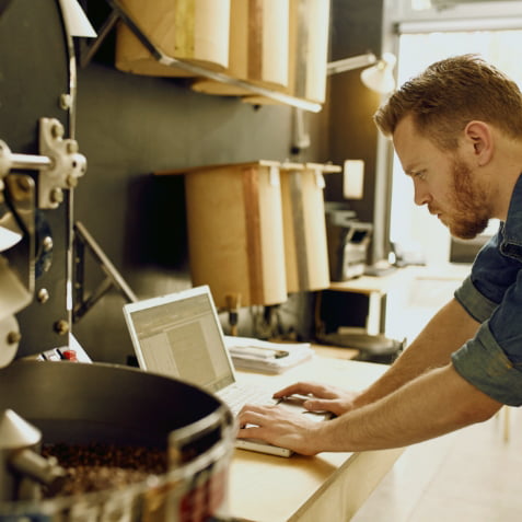 A man typing on a laptop