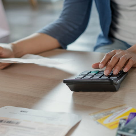 Man using a calculator on his desk